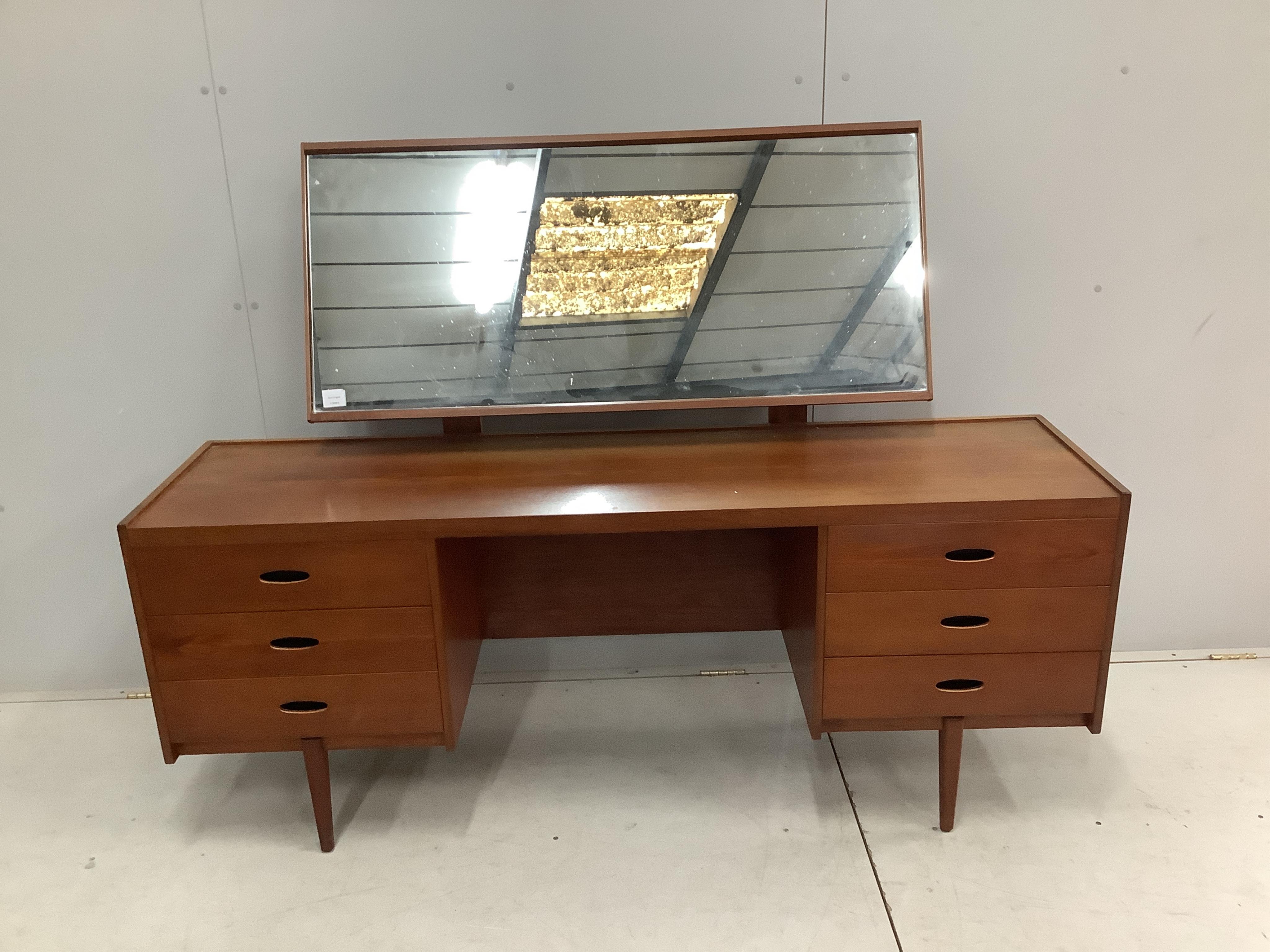 An Austin Suite teak dressing table, width 168cm, depth 44cm, height 126cm